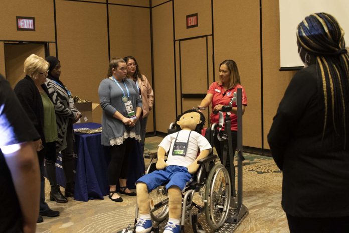 Maritza Valentin, national account manager for AMF-Bruns America, leads the Wheelchair Securement Boot Camp Training Hosted by AMF-Bruns on Nov. 21, 2021 at the TSD Conference.