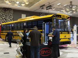 STN EXPO Reno attendees visit the BYD exhibit on Dec. 8, 2021. The Chinese manufacturer is the latest to announce it is entering the electric school bus market. (Photo by Taylor Hannon.)