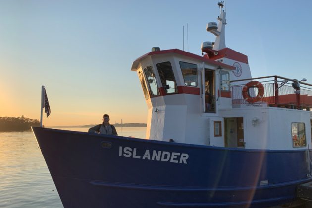 Ann Kirkpatrick, superintendent of the Chebeague Island School District,stands at the bow of "The Islander" on the way to school.