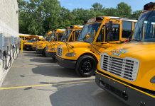 A row of five new electric Thomas Built Buses sit in their permanent parking spots at Bethlehem Central School District near Albany, New York, which received the vehicles on July 21, 2022 for the new school year.