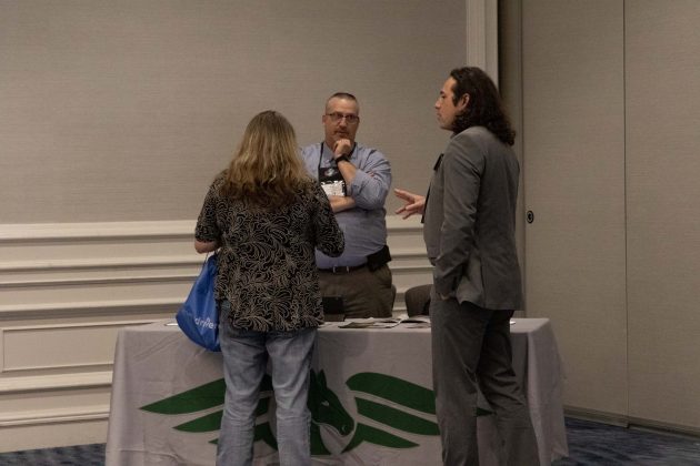 Brian Barrington, the president of Pegasus Specialty Vehicles, speaks with attendees at the 54th Annual NASDPTS Conference in Washington D.C., on Oct. 29, 2022.
