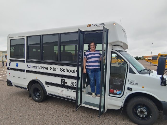 Driver Rhonda Coronado for Adams 12 Five Star Schools in Colorado poses in a non-CDL required vehicle. The district has leaned on the non-CDL program to keep transportation running smoothly amid the school bus driver shortage.