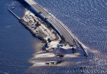 In this aerial photo made in a flight provided by mediccorps.org, damage from Hurricane Ian is seen on the causeway leading to Sanibel Island from Fort Myers, Fla., Friday, Sept. 30, 2022. (AP Photo/Gerald Herbert)