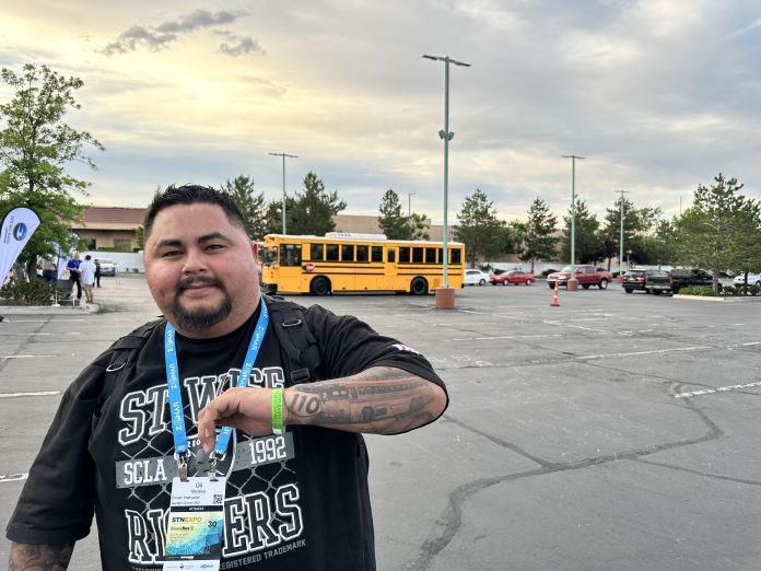 School bus driver-trainer Gil Morales shows off his school bus tattoo at STN EXPO Reno in 2023.