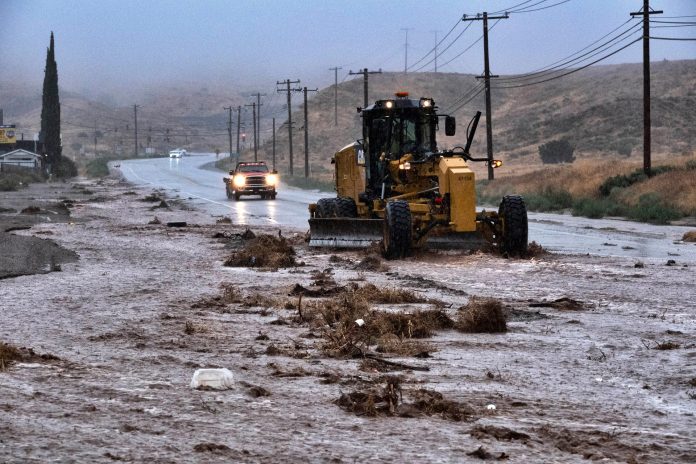 Associated Press photo of a road crew responds a mudslide caused by heavy rains from Tropical Storm Hilary on Sunday, Aug. 19, 2023.
