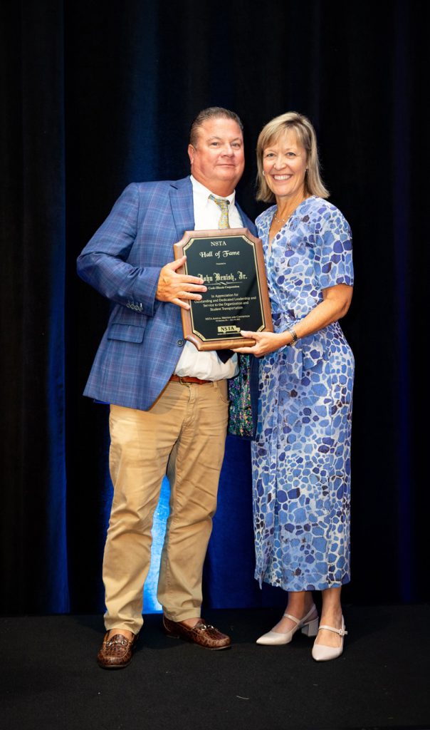 John Benish receives his Hall of Fame award from NSTA Award Committee chair Chloe Williams on July 18, 2023. Photo courtesy of NSTA.