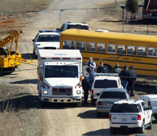 The school bus driven by Joyce Gregory is towed from the place where it crashed into a utility pole after Gregory was fatally shot in Cumberland City, Tenn., Wednesday, March 2, 2005. Officials said a 14-year-old male student was taken into custody. None of the 24 students on the bus were hurt.(AP Photo/The Tennessean, Larry McCormack)