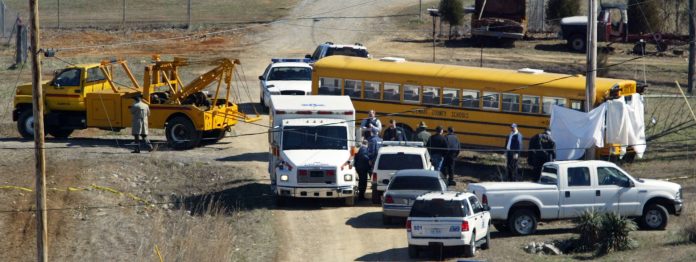 The school bus driven by Joyce Gregory is towed from the place where it crashed into a utility pole after Gregory was fatally shot in Cumberland City, Tenn., Wednesday, March 2, 2005. Officials said a 14-year-old male student was taken into custody. None of the 24 students on the bus were hurt.(AP Photo/The Tennessean, Larry McCormack)