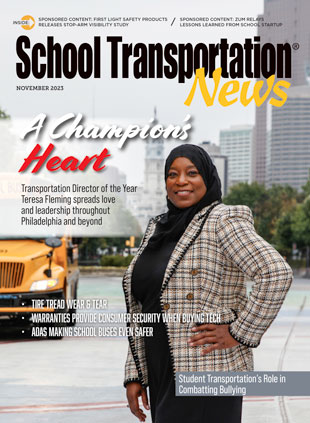 Teresa Fleming poses in front of the inspiring Philadelphia skyline and one of the school district’s buses. Fleming is recognized this month as the latest STN Transportation Director of the Year for her leadership. Photo by Taylor Ekbatani