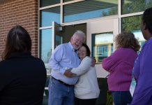 Denny Coughlin, owner of the School Bus Training Company and Regina Shirk, a school bus driver for University Place School District in Washington, embrace a after an emotional evacuation drill at the 2023 TSD Conference.