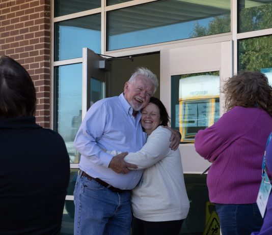 Denny Coughlin, owner of the School Bus Training Company and Regina Shirk, a school bus driver for University Place School District in Washington, embrace a after an emotional evacuation drill at the 2023 TSD Conference.