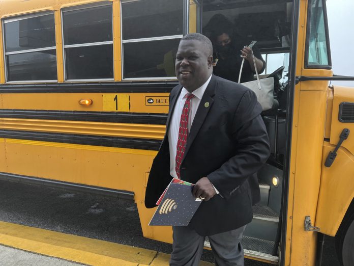 Superintendent Dr. Frederick Williams of Dublin City Schools in Georgia steps off a school bus.