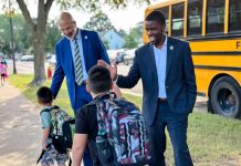 Dr. Joe Gothard (left), the superintendent for Saint Paul Public Schools in Minnesota, greets students on the first day of school for 2023-2024 alongside Mayor Melvin Carter.