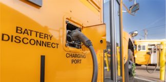An electric school bus receives its charge.